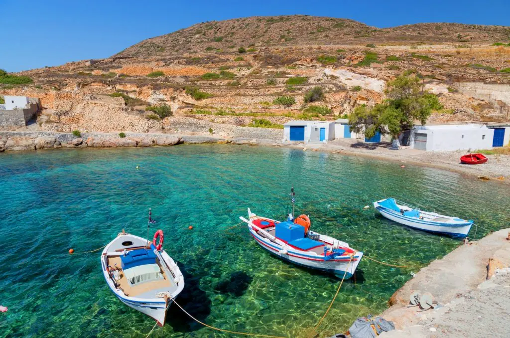 Traditional fishing boats moored in a small harbour on Kimolos
