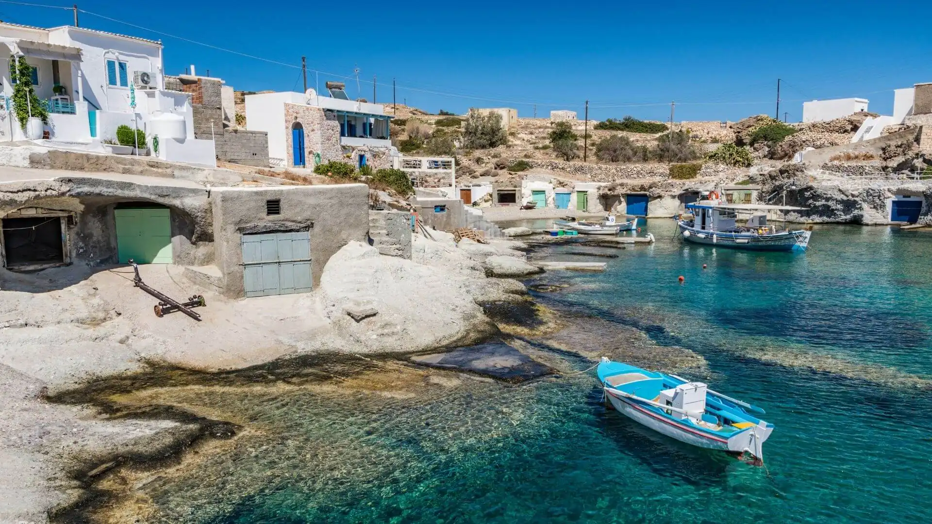 Fishing boats and syrmata boathouses in a Kimolos cove