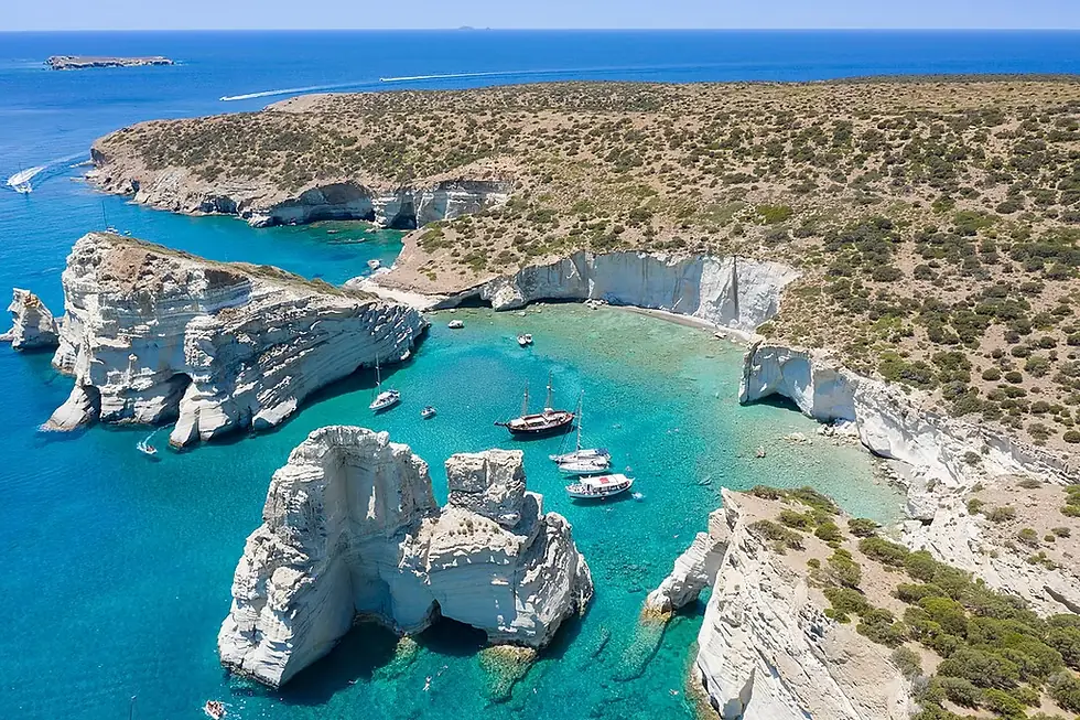Aerial view of the rock formations and boats at Kleftiko, Milos