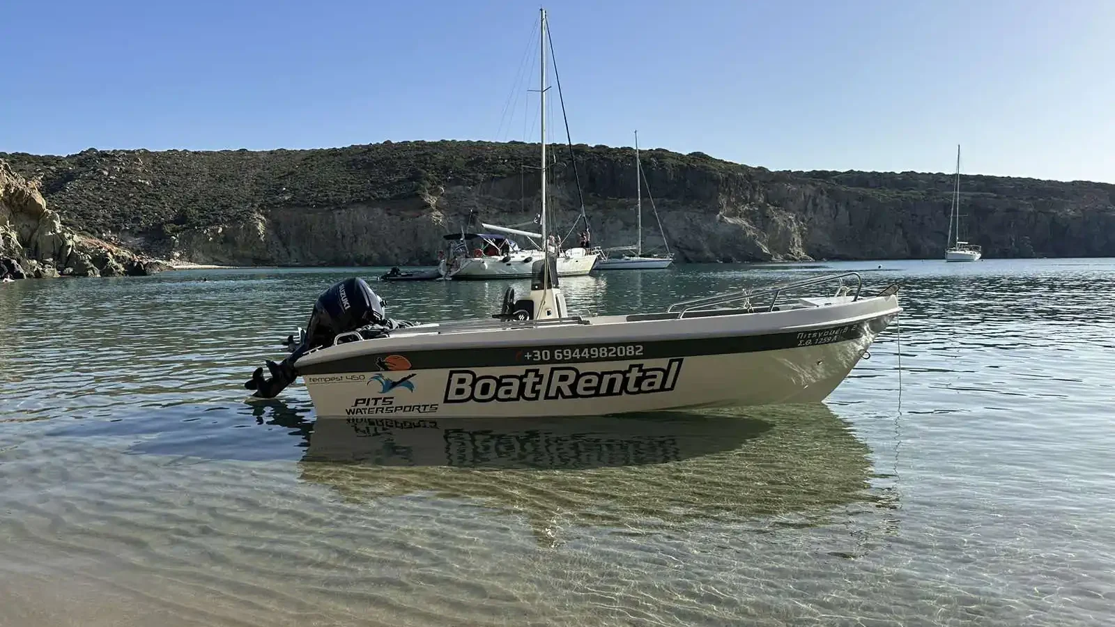 Pits Watersports rental boat anchored in shallow clear water
