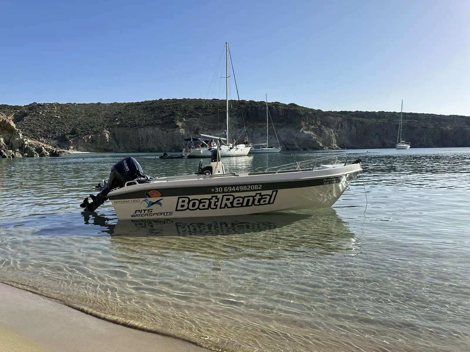 Pits Watersports rental boat in a calm bay with sailboats