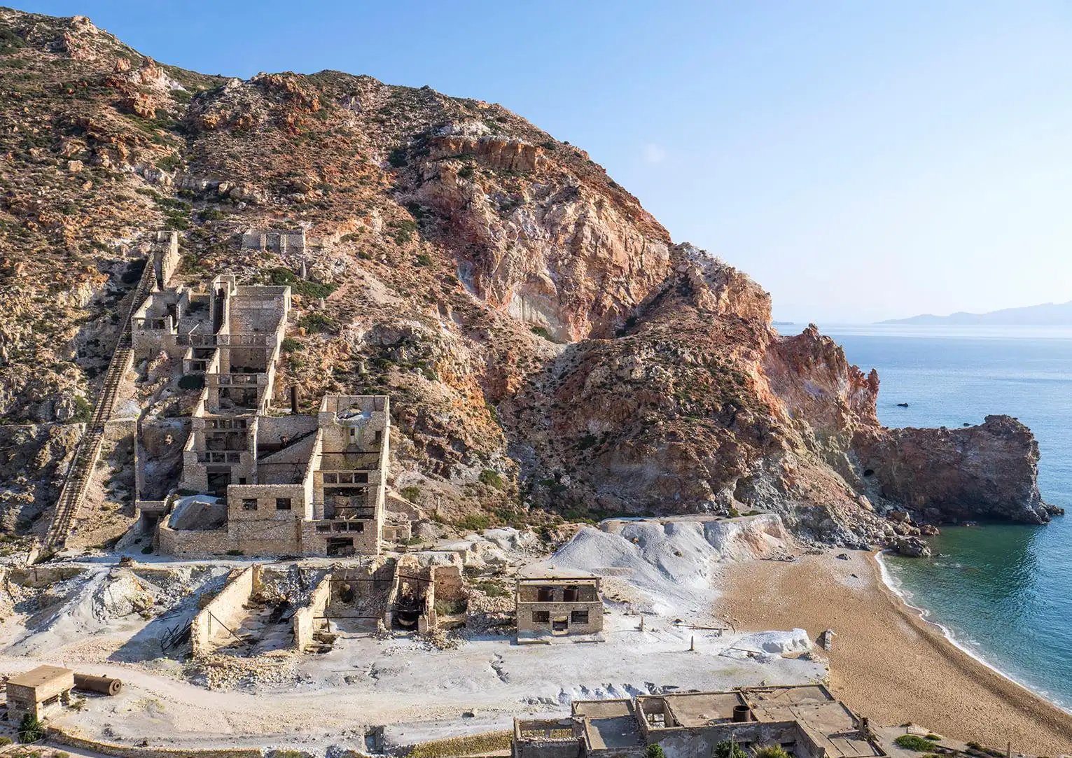 Abandoned buildings of the Sulfur Mines above the beach in Milos